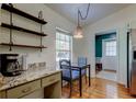 Inviting breakfast nook area with granite countertops and a view from the window at 17631 Grove View Dr, Lutz, FL 33549