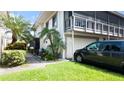 Two story home showing the garage, lush landscaping, and an inviting outdoor space at 1851 Bough Ave # A, Clearwater, FL 33760
