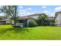 Lush lawn and landscaping surround the neutral-colored home, creating a serene atmosphere at 1851 Bough Ave # A, Clearwater, FL 33760