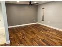 Spacious bonus room boasts beautiful hardwood floors, neutral paint and stylish ceiling fan at 206 Hillcrest Dr, Safety Harbor, FL 34695