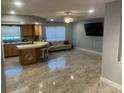 Open-concept living room with modern kitchen, stainless appliances and ceramic tile floors at 206 Hillcrest Dr, Safety Harbor, FL 34695