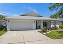 Well-maintained single-Gathering home featuring a two-car garage and manicured front lawn at 2108 Delightful Dr, Ruskin, FL 33570