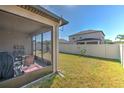 Enclosed patio with outdoor furniture and a spacious, well-maintained backyard at 25200 Lambrusco Loop, Lutz, FL 33559