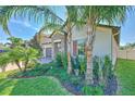 Single-Gathering home featuring a brick driveway and a well-maintained front lawn at 25200 Lambrusco Loop, Lutz, FL 33559