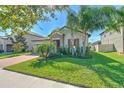 Single-Gathering home featuring a brick driveway and a well-maintained front lawn at 25200 Lambrusco Loop, Lutz, FL 33559