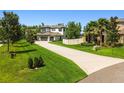 Beautiful home with a well-maintained lawn and spacious driveway, surrounded by green trees at 2648 Lake Manor Dr, Land O Lakes, FL 34639