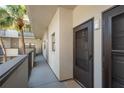 Condo entrance on a balcony walkway with view of palm trees at 2650 Countryside Blvd # C204, Clearwater, FL 33761