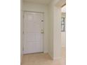 Interior entrance featuring a tile floor and a white door at 2650 Countryside Blvd # C204, Clearwater, FL 33761
