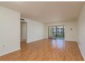 Living room with hardwood floors and sliding glass doors to balcony at 2650 Countryside Blvd # C204, Clearwater, FL 33761
