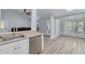Open-concept kitchen with stainless steel dishwasher and view into the adjacent dining area at 2770 Steeple Ct, Palm Harbor, FL 34684
