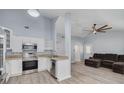 Bright kitchen featuring white cabinets, stainless steel appliances, and an open layout at 2770 Steeple Ct, Palm Harbor, FL 34684