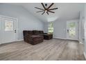 Inviting living room with high ceilings, a ceiling fan, and modern flooring at 2770 Steeple Ct, Palm Harbor, FL 34684