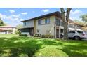 Two-story condo with an attached garage and manicured landscaping at 2941 Lichen Ln # B, Clearwater, FL 33760