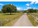 Long driveway leading to a charming home, offering privacy and a sense of tranquility at 31949 Amberlea Rd, Dade City, FL 33523