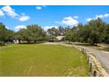 Expansive property with green pastures, mature trees, and a home with an extended driveway at 31949 Amberlea Rd, Dade City, FL 33523