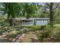 Charming single-story home with a screened porch and well-maintained landscaping at 3373 Olson Rd, Spring Hill, FL 34607