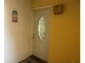 Charming front door with decorative glass and beach themed wall art providing a welcoming entry at 3640 41St S Ln # F, St Petersburg, FL 33711