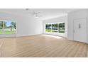 Bright living room with lots of natural light, hardwood floors and an open floor plan at 4030 Moores Lake Rd, Dover, FL 33527