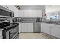 Modern kitchen featuring white cabinets and stainless steel appliances at 4306 Bayside Village Dr # 201, Tampa, FL 33615