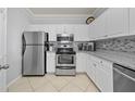 Bright kitchen with stainless steel appliances and granite countertops at 4306 Bayside Village Dr # 201, Tampa, FL 33615