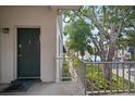 Inviting entry door leading to pool views and community area, surrounded by beautiful vegetation at 4325 Aegean Dr # 250B, Tampa, FL 33611