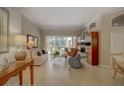 Bright living room with tile flooring and large windows overlooking the pool area at 4335 Clairidge Way, Palm Harbor, FL 34685