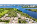 Aerial view of the community showcasing homes nestled among trees, ponds, and lush greenery at 4567 Tuscan Loon Dr, Tampa, FL 33619