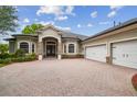 Gorgeous home with a three-car garage and a stylish stone-accented facade at 505 Vintage Way, Brandon, FL 33511