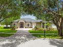 Beautifully landscaped home with mature trees providing shade and enhancing its curb appeal at 505 Vintage Way, Brandon, FL 33511