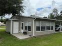 Home with a sunroom addition featuring multiple windows and attached carport at 5105 Wood St, Zephyrhills, FL 33542