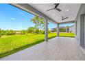 Spacious covered patio with tile flooring, ceiling fans, and views of the expansive backyard at 5317 Lydia Ct, Spring Hill, FL 34608