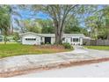Charming single-story home with manicured lawn and mature tree in the front yard at 5625 Atlantic N Ave, St Petersburg, FL 33703