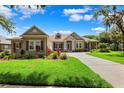 Charming single-story home with a well-manicured lawn, mature landscaping, and inviting curb appeal at 5823 Terncrest Dr, Lithia, FL 33547