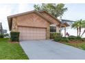 Charming single Gathering home features a two car garage, stone accents, and lovely landscaping at 6340 Garland Ct, New Port Richey, FL 34652