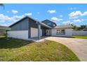 Two-story home featuring an attached two car garage, double door entry and a spacious front yard at 6841 Mitchell Cir, Tampa, FL 33634