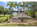 Beautiful stone community sign with lush landscaping and palm trees at 6934 Duffy Ln, Tampa, FL 33616