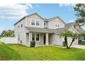 A charming home with a lush green lawn, complemented by two palm trees at 7509 Tangle Bend Dr, Gibsonton, FL 33534