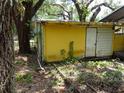 Back side of a cottage surrounded by foliage at 8617 Broad St, New Port Richey, FL 34654