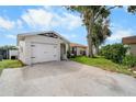 A lovely single-story home that features a attached garage, landscaping, and great curb appeal at 10202 Bellhurst Ct, Tampa, FL 33615