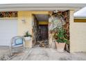Charming front entrance featuring stone accents and a cozy sitting area to welcome guests at 1117 S Florida Ave, Tarpon Springs, FL 34689