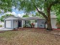 Charming single-story home features a well-maintained lawn, attached garage, and cozy front porch at 1135 17Th Sw Ave, Largo, FL 33778