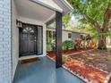Inviting front porch boasts stylish tile flooring, and decorative landscaping at 1135 17Th Sw Ave, Largo, FL 33778