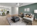 Bright living room features modern furniture, light wood floors, and a large window at 1135 17Th Sw Ave, Largo, FL 33778
