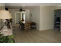 Open dining area with tile floors, modern lighting, and neutral tones providing versatile living space at 12794 Palm Dr, Largo, FL 33774
