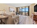Comfortable living area with neutral tones, coastal views, and access to a large balcony, enhancing the living experience at 1290 Gulf Blvd # 702, Clearwater Beach, FL 33767