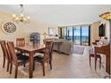 Inviting living room with ocean view, comfortable seating, dining area, and ample natural light perfect for relaxation and entertaining at 1290 Gulf Blvd # 702, Clearwater Beach, FL 33767
