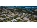 Aerial view showcases the neighborhood, nearby waterways, and lush landscaping, highlighting a peaceful community at 14534 Yacht Club Blvd, Seminole, FL 33776