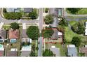 Aerial view of a property in a neighborhood with mature trees near a calm, winding road at 15028 Redcliff Dr, Tampa, FL 33625