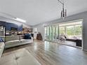 Open floor plan with hardwood floors, modern kitchen, and an inviting sunroom at 1609 Haven Bnd, Tampa, FL 33613