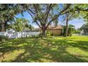 Expansive backyard featuring lush greenery, mature trees, and a privacy fence at 1715 Larabie Ct, Brandon, FL 33511